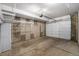 Spacious and unfinished garage with concrete walls and floor, offering ample storage and parking space at 2103 W 32Nd Ave # 10, Denver, CO 80211