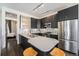 Modern kitchen with dark cabinets, stainless steel appliances, and a quartz countertop island with bar seating at 2103 W 32Nd Ave # 10, Denver, CO 80211