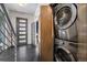 Convenient laundry area featuring a stacked washer and dryer, and stylish door at 2103 W 32Nd Ave # 10, Denver, CO 80211
