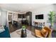 Open-concept living space with modern furniture, a dining area, and dark hardwood floors, next to the kitchen at 2103 W 32Nd Ave # 10, Denver, CO 80211