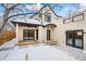 Backyard with snow, patio, porch, modern architecture, and wooden fence under a bright sky at 2434 Mapleton Ave, Boulder, CO 80304