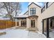 Backyard with snow, patio, porch, modern architecture, and wooden fence under a cloudy sky at 2434 Mapleton Ave, Boulder, CO 80304