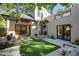 Outdoor space showcasing a patio with stylish seating, a green lawn area, and elegant access to the home's interior at 2434 Mapleton Ave, Boulder, CO 80304