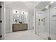 Bright bathroom showcasing double vanities and a glass-enclosed shower with gold fixtures at 2434 Mapleton Ave, Boulder, CO 80304