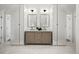 Modern bathroom featuring double vanities, square mirrors, and unique herringbone tile flooring at 2434 Mapleton Ave, Boulder, CO 80304