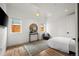 Well-lit bedroom with wood floors, accent chair, and stylish decor at 2434 Mapleton Ave, Boulder, CO 80304