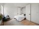 Cozy bedroom with hardwood floors, accent chair, and spacious closet at 2434 Mapleton Ave, Boulder, CO 80304