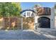 Stylish home with a wooden gate, black garage door, and a balcony area, offering a unique architectural design at 2434 Mapleton Ave, Boulder, CO 80304