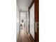 Hallway with natural light, decorative sliding door, and hardwood floors at 2434 Mapleton Ave, Boulder, CO 80304