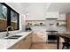Bright kitchen with marble countertops, modern hardware, open shelving, and stainless steel appliances at 2434 Mapleton Ave, Boulder, CO 80304