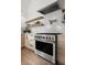 Modern stainless steel oven with brass accents and wooden cabinetry at 2434 Mapleton Ave, Boulder, CO 80304
