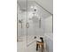 Modern shower with glass enclosure, white tile, gold fixtures, and unique design niche at 2434 Mapleton Ave, Boulder, CO 80304