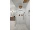 Modern shower showcasing white subway tile, gold fixtures and a glass door at 2434 Mapleton Ave, Boulder, CO 80304