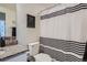 Bathroom featuring granite counters, a white vanity, and a shower with a black and white curtain at 16841 Askins Loop # 105, Parker, CO 80134