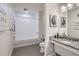 Bright bathroom features a granite countertop, a white vanity, and a shower-tub combination at 16841 Askins Loop # 105, Parker, CO 80134