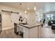 Modern kitchen features granite counters, an island with a sink, and stainless steel appliances at 16841 Askins Loop # 105, Parker, CO 80134