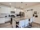 Contemporary kitchen featuring white cabinets, granite countertops, stainless steel appliances and kitchen island at 16841 Askins Loop # 105, Parker, CO 80134