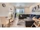Bright living room with large sectional, glass dining table, and sliding glass doors to the patio at 16841 Askins Loop # 105, Parker, CO 80134