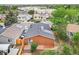 Aerial view of a home highlighting the back deck, roof, and proximity to nearby houses and greenery at 2393 E 90Th Ave, Thornton, CO 80229