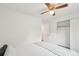 Bright bedroom features a ceiling fan and closet with sliding doors for ample storage at 2393 E 90Th Ave, Thornton, CO 80229