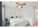 Cozy bedroom with a queen size bed, ceiling fan, and a view to the outside at 2393 E 90Th Ave, Thornton, CO 80229