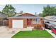 Charming single-story home with a well-manicured lawn, red door, and attached one car garage at 2393 E 90Th Ave, Thornton, CO 80229