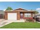 Charming single-story home with wood siding, a manicured lawn, and an attached one car garage at 2393 E 90Th Ave, Thornton, CO 80229