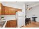 Cozy kitchen flows to a dining area with natural wood cabinets and white appliances at 2393 E 90Th Ave, Thornton, CO 80229