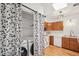 Kitchen featuring wood cabinets with laundry area behind curtain divider at 2393 E 90Th Ave, Thornton, CO 80229