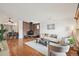 Bright living room features an open layout, hardwood floors, fireplace, and comfortable seating area at 2393 E 90Th Ave, Thornton, CO 80229
