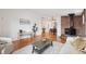 Bright living room boasts hardwood floors, brick fireplace, and large window for natural light at 2393 E 90Th Ave, Thornton, CO 80229