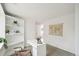 Bright office with built-in shelves, a modern white desk, a window view, and gray carpet at 2393 E 90Th Ave, Thornton, CO 80229