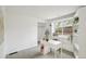 Bright office with built-in shelves, a modern white desk, a window view, and gray carpet at 2393 E 90Th Ave, Thornton, CO 80229