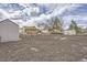 Spacious backyard showcasing landscaping features and multiple storage sheds at 1254 S Osceola St, Denver, CO 80219