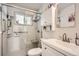 Bathroom featuring glass shower with a bench and a sink at 1254 S Osceola St, Denver, CO 80219