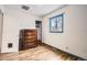 Bedroom with hard wood floors, wood dresser and a window at 1254 S Osceola St, Denver, CO 80219