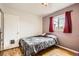 Comfortable bedroom with wood floors and window at 1254 S Osceola St, Denver, CO 80219