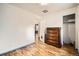 Bright bedroom featuring wood floors, neutral walls, and a spacious closet at 1254 S Osceola St, Denver, CO 80219