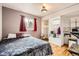 Comfortable bedroom with wood floors, window and built-in storage at 1254 S Osceola St, Denver, CO 80219