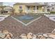 Exterior view of a yellow home featuring a landscaped front yard with white planters and heart-shaped feature at 1254 S Osceola St, Denver, CO 80219
