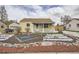Charming, yellow single-story home featuring a landscaped front yard and a welcoming, covered porch at 1254 S Osceola St, Denver, CO 80219