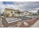 Quaint, yellow home with a landscaped front yard, raised garden beds, rock accents, and a covered porch at 1254 S Osceola St, Denver, CO 80219