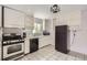 Traditional-style kitchen featuring black appliances and ample white cabinetry at 1254 S Osceola St, Denver, CO 80219