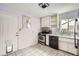 Kitchen with a stove, black appliances and window with plants at 1254 S Osceola St, Denver, CO 80219