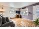 Cozy living room with hardwood floors, large windows, and a comfortable gray couch at 1254 S Osceola St, Denver, CO 80219