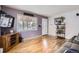 Bright living room boasts hardwood floors, large windows, neutral walls and comfortable seating at 1254 S Osceola St, Denver, CO 80219