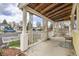 Covered front porch featuring white columns, lattice details, and ample space for seating and decor at 1254 S Osceola St, Denver, CO 80219