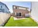 Backyard features a brick patio with a built in grill, artificial grass, and a privacy fence at 18639 E 50Th Pl, Denver, CO 80249