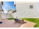 A fenced backyard area features artificial turf and a brick patio with a built-in grill at 18639 E 50Th Pl, Denver, CO 80249