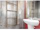 Stylish bathroom with rustic wood ladder detail and pedestal sink at 18639 E 50Th Pl, Denver, CO 80249